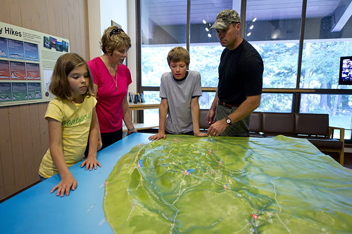 Visitors look at the topographic map of the Porkies