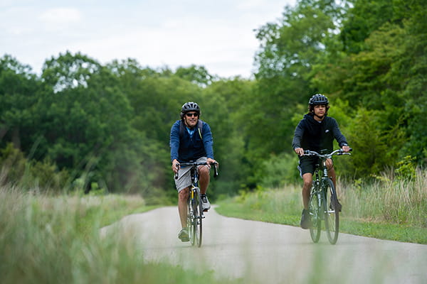 Two people riding bikes on the trail at Van Buren state park