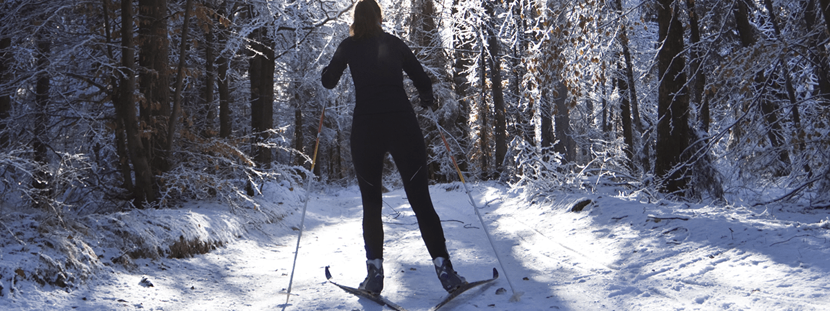 woman skiing on snowy trail