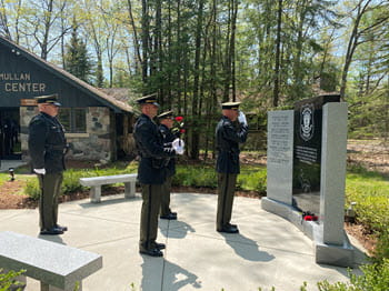 four officers standing in front of a memorial