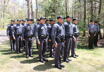 recruits stand outside in ceremony formation