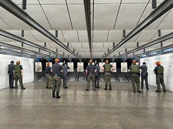 people shooting firearms at a indoor range