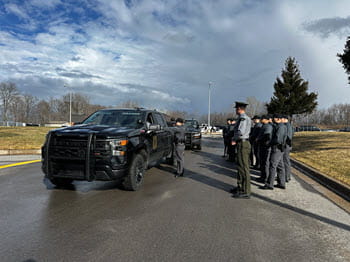 People standing outside of a truck