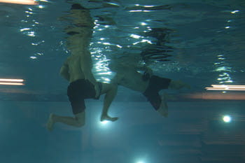 Under water view of two men swimming