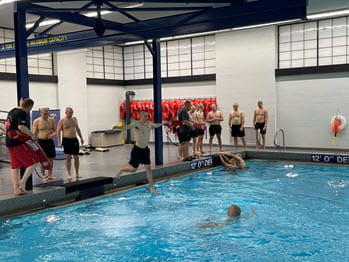 A man practices jumping into a pool