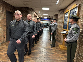 line of people marching in a hall