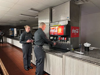 man and woman in a cafeteria line