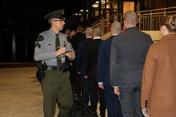 Line of people being checked into a building