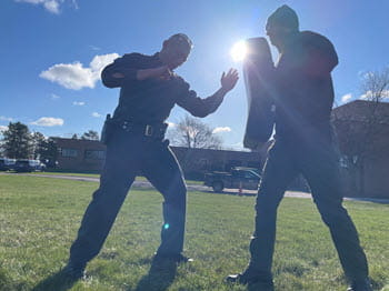 person performing defensive strikes on a pad