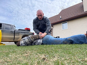 officer in training handcuffing a instructor on the ground
