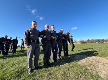 people stand in a line outside with their arms locked to each other