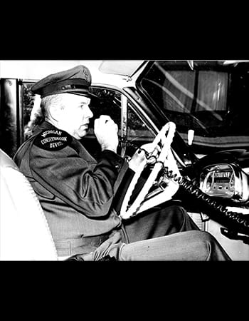 Paul Durham talking on police radio in car