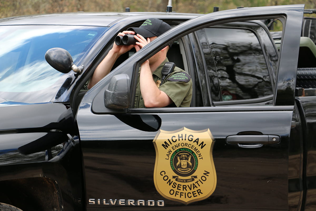 co using binoculars by truck