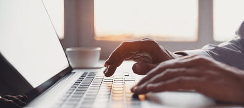 Hands typing on keyboard
