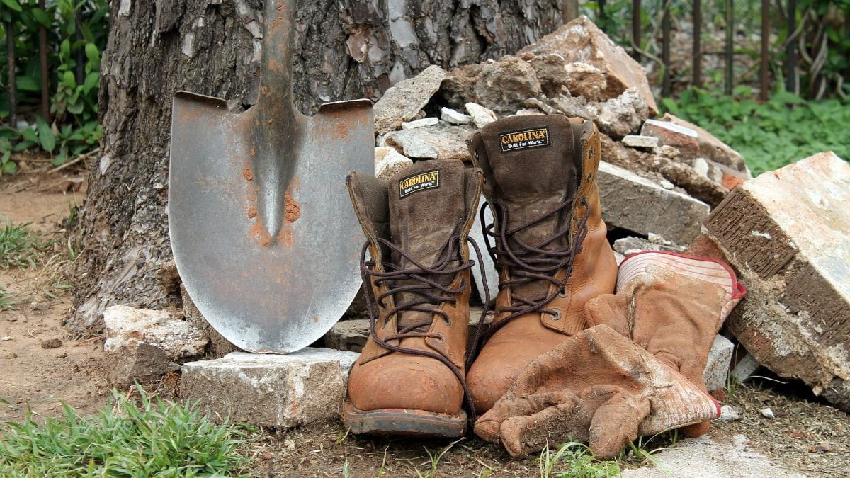 Work boots, leather gloves and a shovel