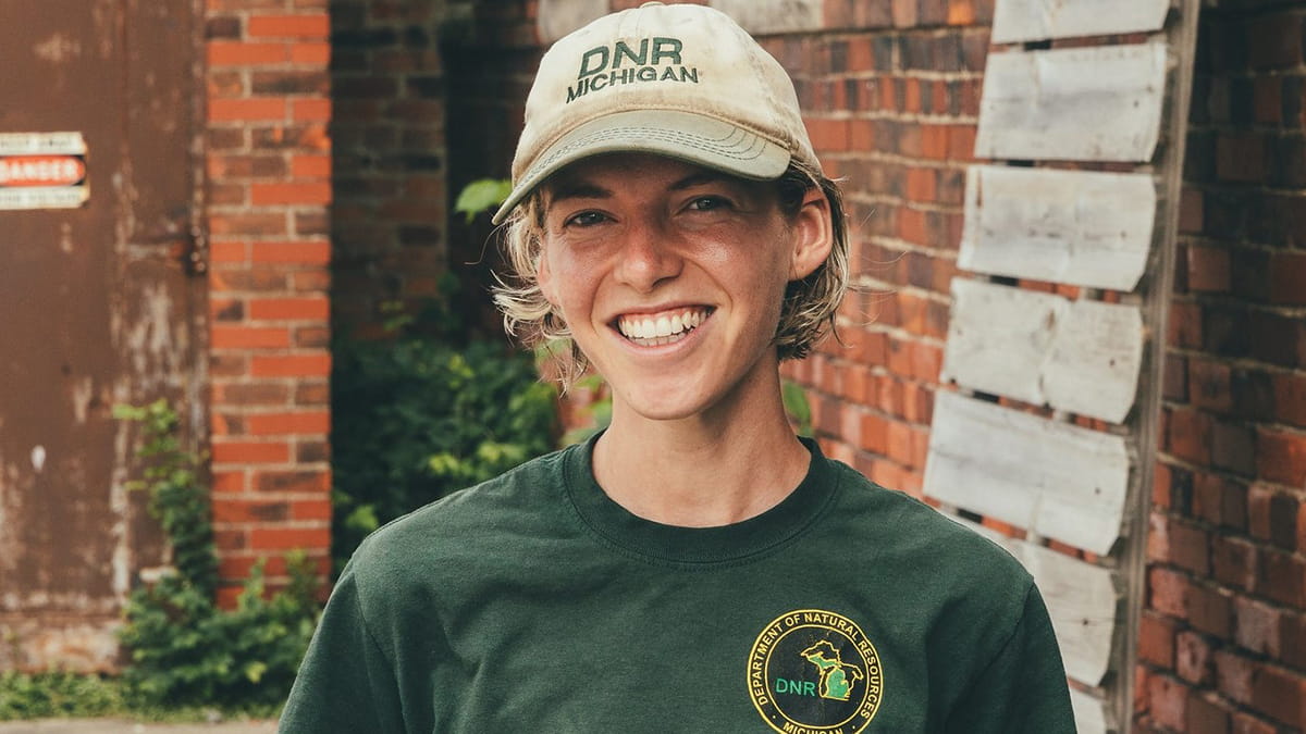 DNR staff member in branded hat and shirt