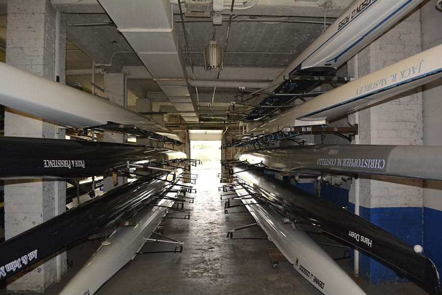 Storage room with racks of multiple-colored boats.