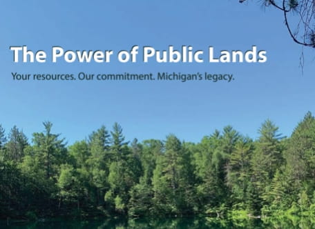 Public Land Strategy cover - a forest and lake, the text "The Power of Public Lands" in white overlaid on the blue sky