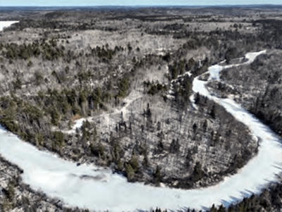 An aerial view of a winding river in the wintertime
