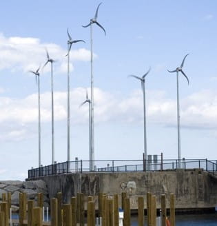 Wind turbines at harbor with a dock in the foreground