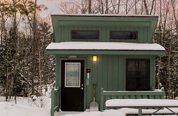 small cabin surrounded by snow