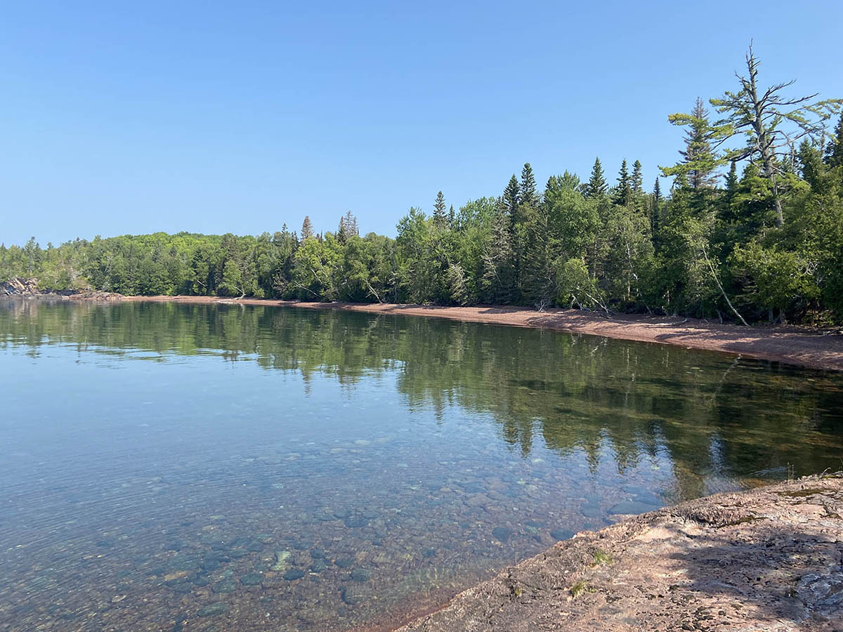 cove surrounded by rocky terrain and trees