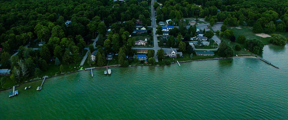 bird's-eye view of lake and private homes
