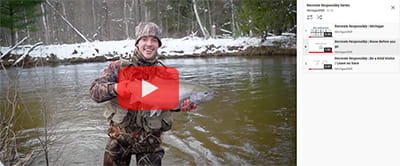 An angler holding a fish with video queued up on side