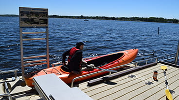 A person using an accessible kayak launch