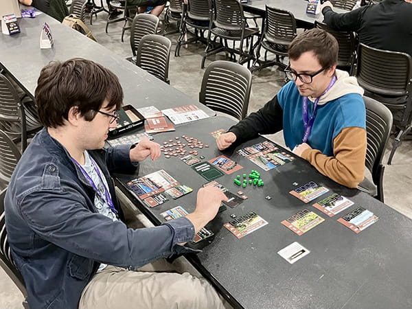 two people playing cards at a table