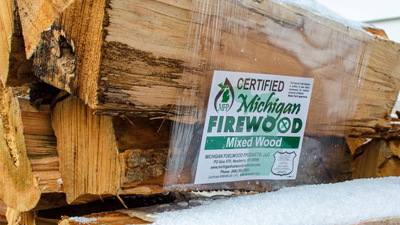 shrink-wrapped firewood with a certified Michigan sticker