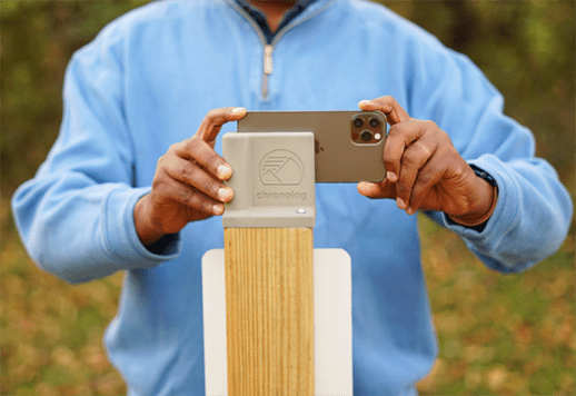 Hands gripping phone on outdoor stand