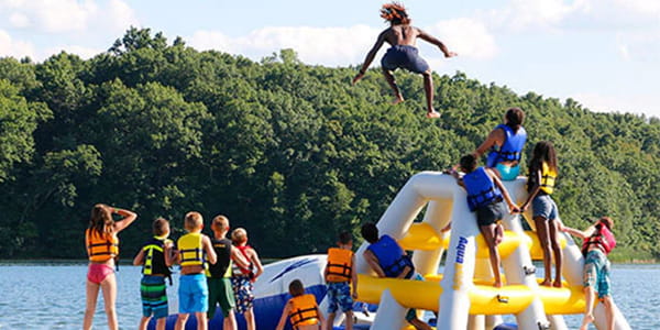 kids playing at floating water park