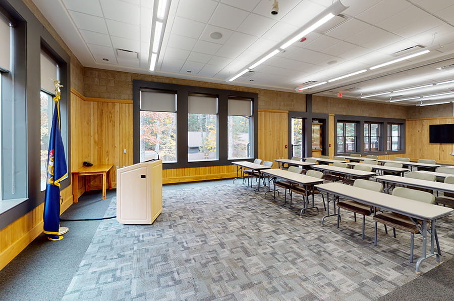 AuSable with tables, chairs, lectern and flag