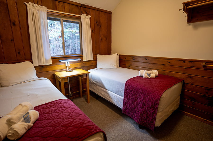 two twin beds with window and night stand
