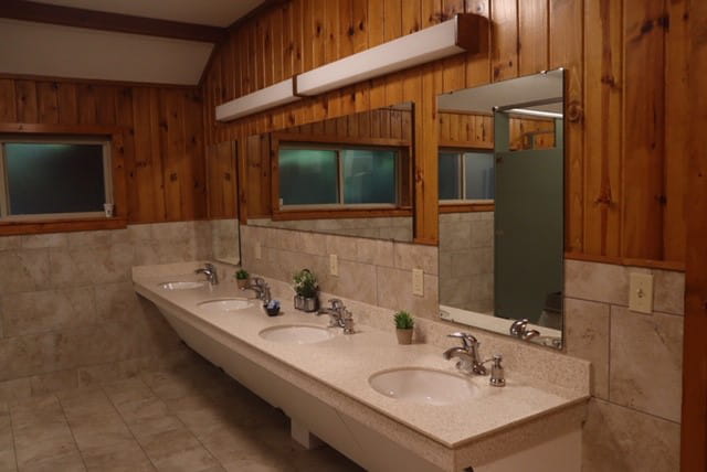 Four sinks in a row, mirrors above the sinks