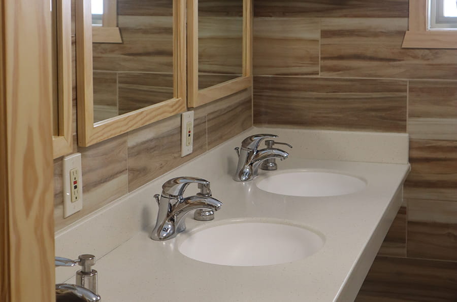 three sinks with a mirror above each sink