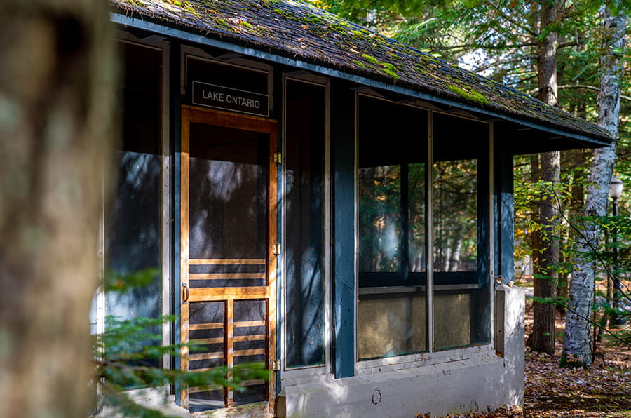 blue-painted lodge with screen-in windows