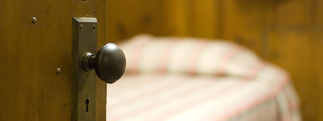 door with blurred bed in the background