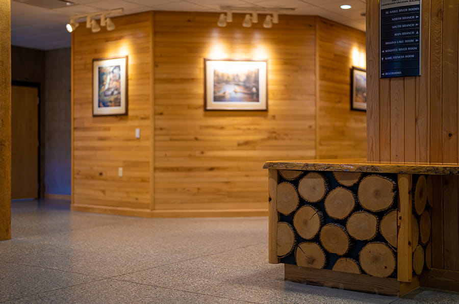 hallway outside meeting rooms with wooden panel walls and counter