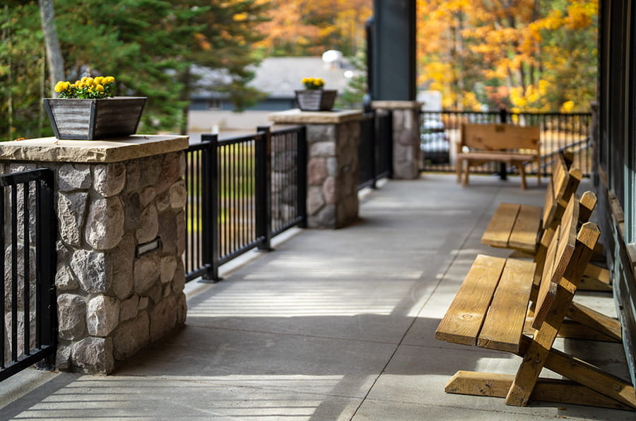benches and flowers on concrete porch