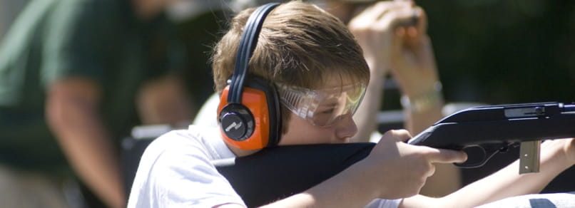 Young man shooting rifle at Ortonville Shooting Range