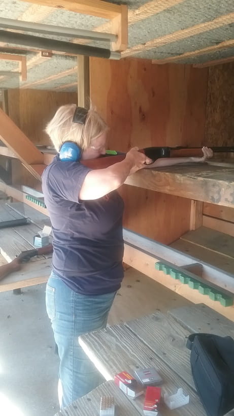 lady target shooting with rifle at Pontiac Lake Shooting Range