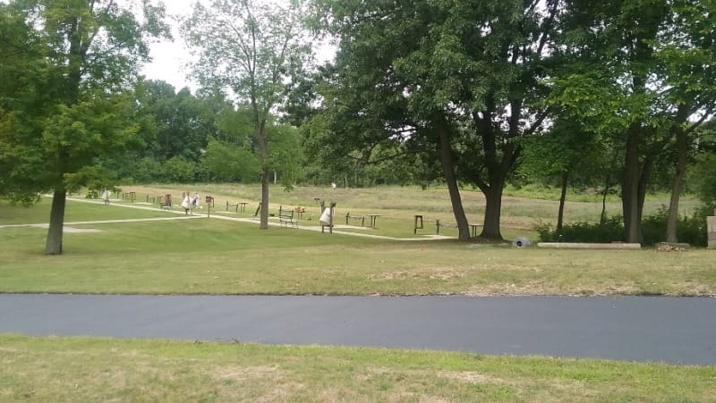Hand trap shooters at Pontiac Lake collect unbroken clay targets from field