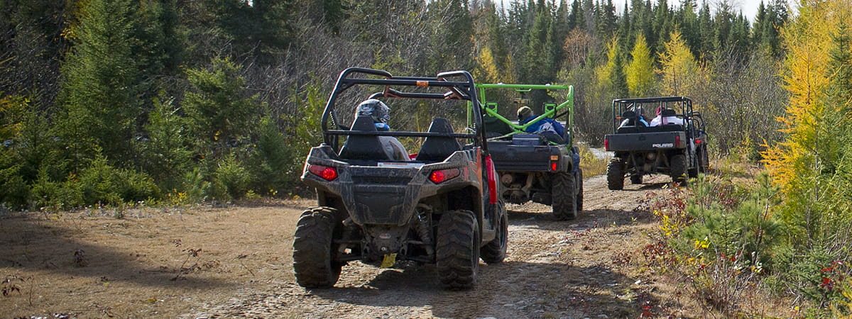 three ORVs riding trail