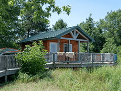 A cabin with a porch and walkway