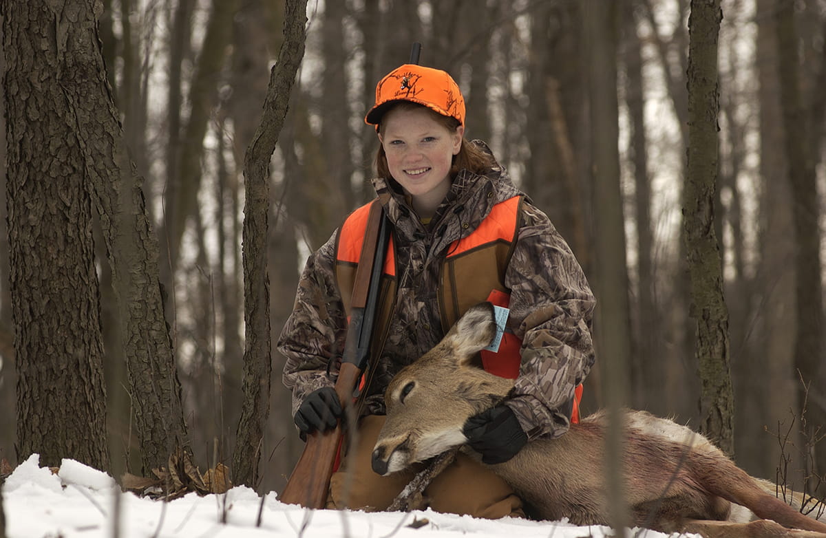 young hunter with deer