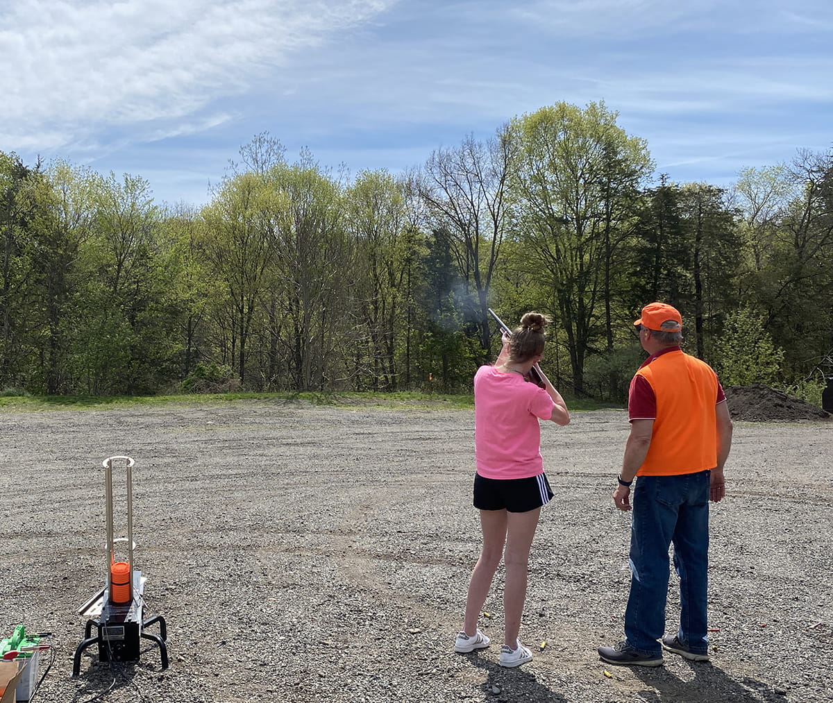 Girl and instructor shooting