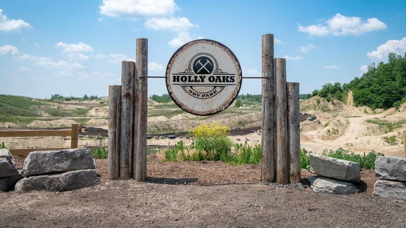 Holly Oaks ORV Park in the background with Holly Oaks sign in the foreground