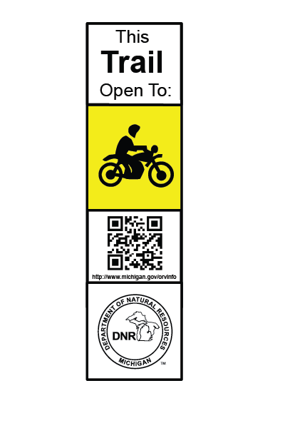 a white and yellow rectangular sign with a motorcycle indicating a motorcycle trail